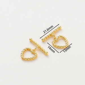 Macro detail of 14k gold-plated heart-shaped OT toggle clasp for DIY jewelry making