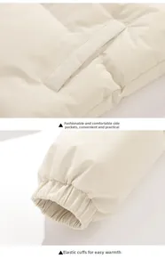 Detail of cream winter puffer jacket featuring side pockets and windproof elastic cuffs