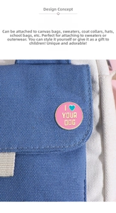 Detail of round pink enamel pin with I Heart Your Dog lettering on a canvas backpack