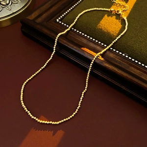 Detailed view of gold beaded flower pearl necklace with lobster clasp and extension chain