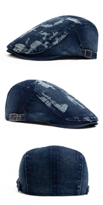 Detail view of distressed blue denim beret with ripped texture and metal side buckle