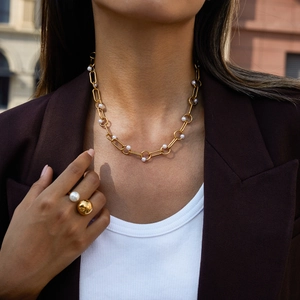 Detail of 18K gold stainless steel chain necklace with pearls and matching double-head ring