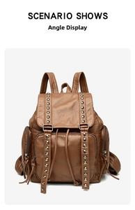 Detail view of brown vintage backpack with metal rivet accents and textured leather