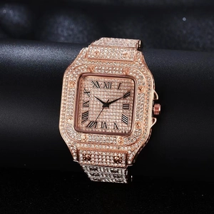 Macro view of gold square watch dial with roman numerals and full diamond pavé detailing