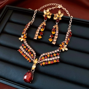 Detail of vintage flower jewelry set with amber stones on black velvet display