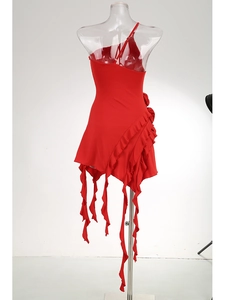 Detail of red one-shoulder dress featuring tiered ruffles and asymmetrical hemline
