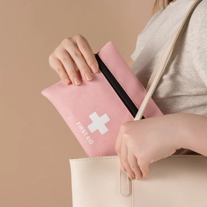 Pink portable first aid kit bag with zipper, compact medical storage pouch for travel use