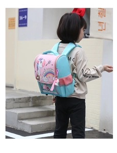 Rear view of child wearing unicorn backpack with blue and pink waterproof canvas texture