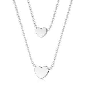 Double-layered silver stainless steel heart pendant necklace for women on white background