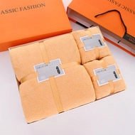 Detailed view of thick orange coral fleece towel and bath robe gift set in box