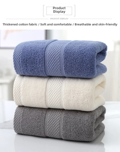 Close-up of thick absorbent cotton towels in blue, beige, and grey with honeycomb texture