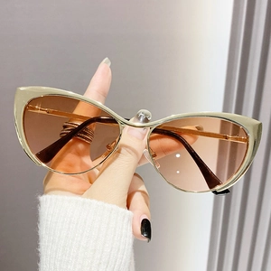 Fashionable metal cat-eye sunglasses with gold frames and brown gradient lenses for women