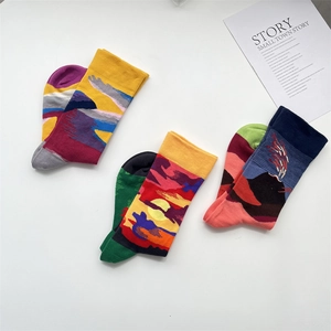 Detailed view of abstract art pattern socks with ribbed cuffs in colorful oil painting style