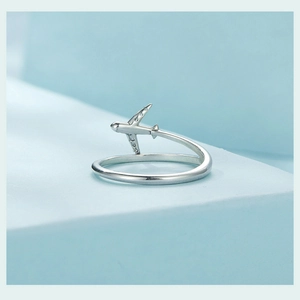 Macro detail of S925 sterling silver airplane ring featuring sparkling cubic zirconia wing
