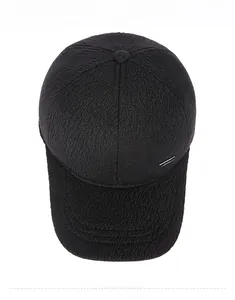 Top view of black thickened winter baseball cap with silver metal plate and twill texture