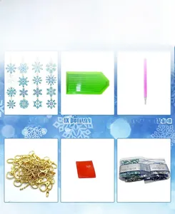 Macro shot of the 5D diamond painting kit featuring blue snowflake charms and tools