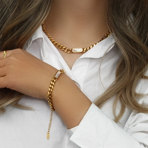 Detail of 18K gold plated Cuban chain jewelry set featuring white rectangular shell charms