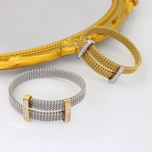 Detail showing gold and silver mesh bracelets with sparkling zircon encrusted clasps