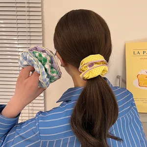 Set of four colorful plaid scrunchies in blue, green, purple and yellow candy colors