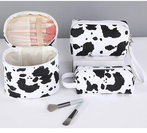 Three-piece set of black and white cow print makeup bags with portable handles and PU leather