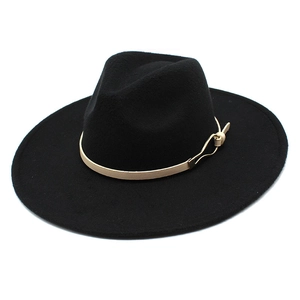 Detail of black wool fedora with a beige leather strap and gold metal buckle accessory