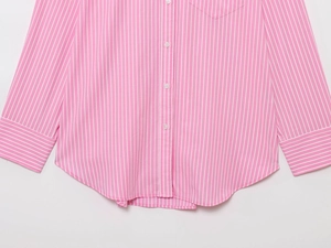 Detailed view of the pink and white striped shirt fabric and button placket design
