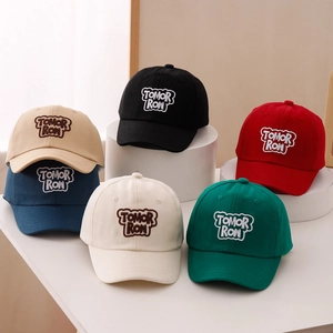 Kids baseball cap set featuring TOMORROW embroidery in six assorted colors on display
