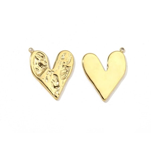 Detail of golden heart pendants with hammered and smooth mirror polished finishes