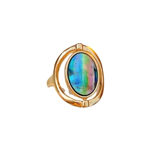 Minimalist gold oval shell open ring with iridescent spinning centerpiece on white background