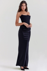 Detail of elegant black strapless mermaid dress with satin pleats and slim fit silhouette