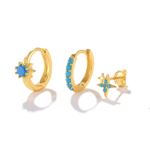 Detailed set of three gold earrings featuring turquoise inlay and a delicate starburst stud