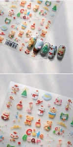 Macro view of TS-3913 3D Christmas bear nail stickers featuring snowman and tree patterns
