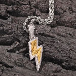 Close-up of hip hop lightning pendant with iced out yellow and white zircons on rope chain