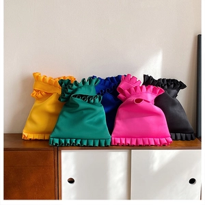Macro detail of multi-colored pleated ruffle shoulder bags in vibrant fabric colors