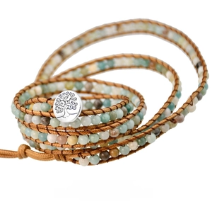Detail of the life tree silver button on a bohemian multi-layer stone bead wrap bracelet