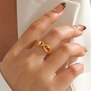 Gold evil eye open ring for women with colorful red and pink enamel on model hand
