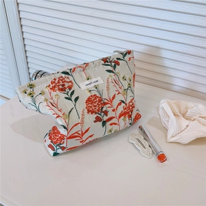Detailed macro view of dandelion floral print canvas pouch with simple wish label text