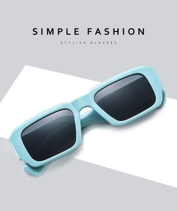 Detail view of stylish light blue rectangular sunglasses with wide temples at a 45-degree angle