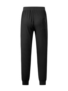 Detail of waffle texture and rear pocket on black men's casual drawstring sweatpants