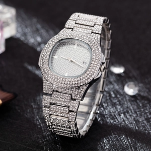 Close-up of a silver iced-out watch with crystal rhinestones and date display feature