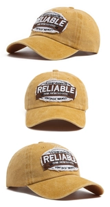 Macro detail of mustard yellow washed cotton baseball cap with oval vintage embroidery