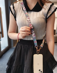 Adjustable crossbody phone strap with vintage pattern and gold metal hardware