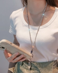Sparkling crystal phone lanyard necklace on model showing its long chain and luxury style