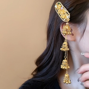 Detailed close-up of golden ethnic hair clip with diamond flower and tassel bells