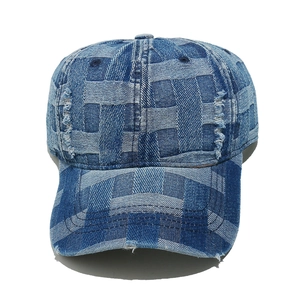 Detailed view of frayed edges and checkered denim texture on a vintage baseball cap