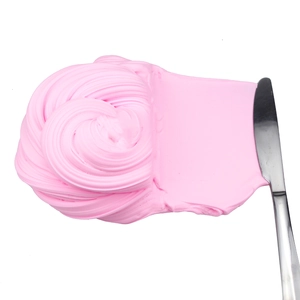 Detailed texture of soft pink cotton butter slime being spread with a metal tool