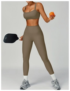 Detail of taupe ribbed seamless yoga set showing high waist leggings and sports bra texture