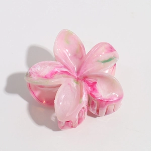 Detail of pink marble effect frangipani hair claw clip with floral acetate texture