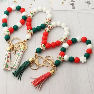 Detail of Christmas silicone bead keychain with snowman patterns and leather tassel
