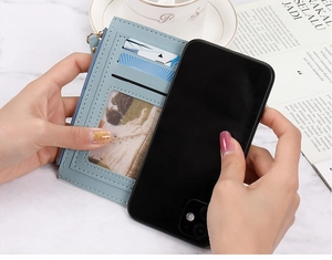 Slim light blue leather wallet with multi-card slots and side zipper shown for size